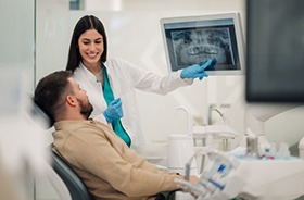 Dentist and patient reviewing X-rays together
