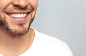 Close-up of man’s healthy teeth after receiving fillings