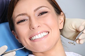 Woman smiling during dental treatment