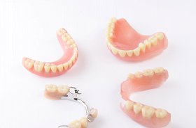 Illustration of implant dentures for lower arch against white background
