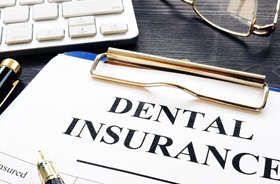 Patient at dental reception desk, learning about payment options