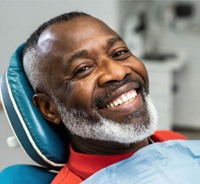Smiling older man in dental treatment chair