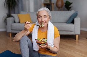 Fit older woman eating a salad