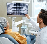 Dentist consulting with senior patient
