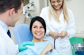 Woman smiles at her Plymouth emergency dentist after emergency appointment