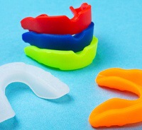 Colorful mouthguards on blue background