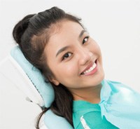 Smiling dental patient in treatment chair