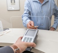 Patient using card to pay for treatment