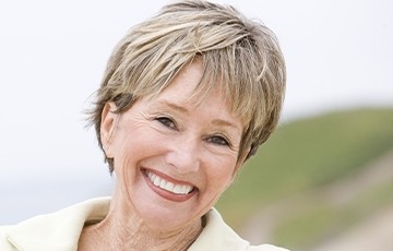Woman in white jacket smiling