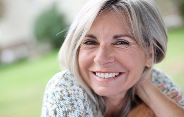 Smiling older woman outdoors in flowery blouse