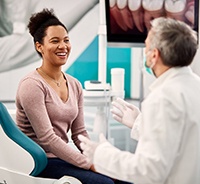 Dentist and patient discussing details of dental implant treatment