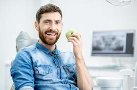 Happy male patient after successful dental implant salvage