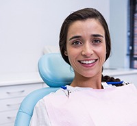 Young woman smiles after getting dental implants in Plymouth