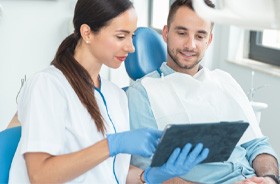 Dentist and patient discussing treatment plan