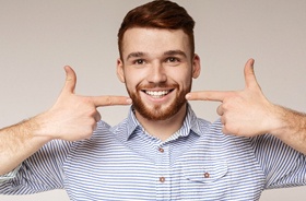 Happy young man enjoying benefits of periodontal therapy