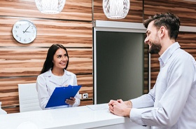Patient paying for treatment at dental office front desk