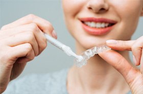 Woman filling tray with whitening formula