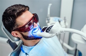 Male patient relaxing during in-office whitening treatment