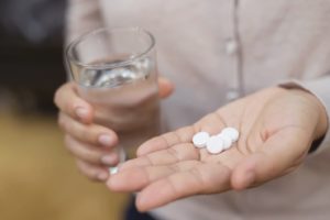 patient preparing to take antibiotics prior to tooth extraction 