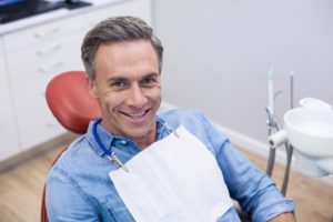 Happy man at appointment to maximize dental insurance benefits