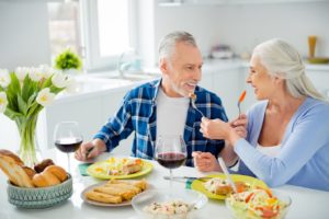 Mature couple with dentures in Plymouth enjoying a meal