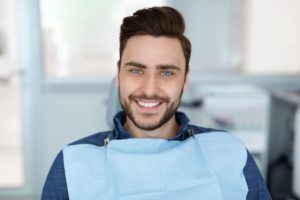 Handsome male dental patient in treatment chair