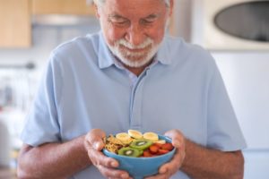 Senior man holding a bowl of nutritious food