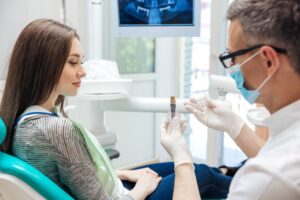 Dentist and patient talking about dental implants