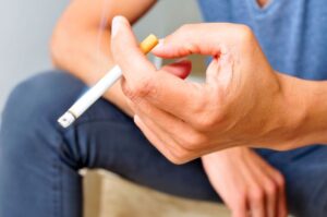 Close-up of cigarette in man’s hand 